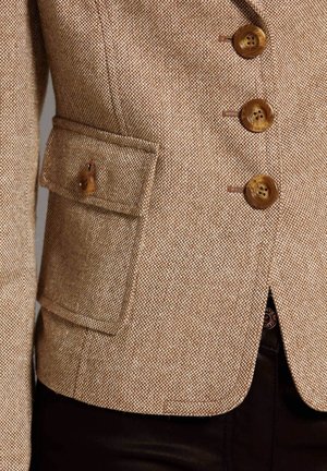 Bruine gestructureerde blazer met een getailleerd ontwerp, voorzien van vier grote bruine knopen en een zijzak met knoopsluiting.