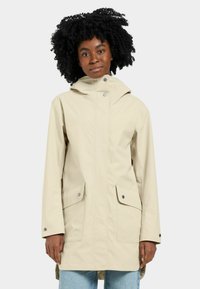 Beige vattentålig jacka med huva, två framfickor och tryckknappar. Slät tygkonstruktion med en avslappnad passform och långa ärmar.