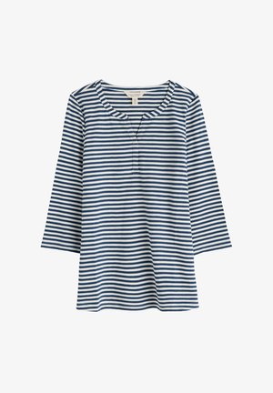 Pruhovaný top s dlouhým rukávem v modro-bílých vodorovných pruzích, s kulatým výstřihem a lištou na tři knoflíky. Vyrobeno z měkké bavlněné tkaniny.