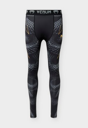 Mustad kompressioonpüksid halli madu soomusmustriga ja kuldsete detailidega, millel on "VENUM" kaubamärgiga vöökoht.