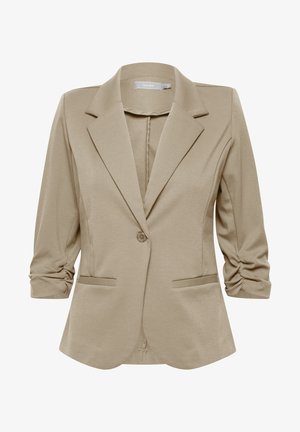 Blazer beige à coupe ajustée, avec des revers crantés, fermeture à un bouton, et manches retroussables. Deux poches avant. Tissu lisse et texturé.