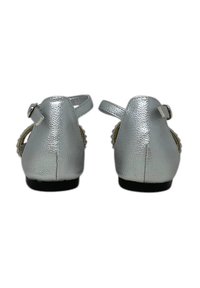 Scarpe in finta pelle argento con tacco basso, cinturino alla caviglia e dettaglio intrecciato sui lati. Finitura testurizzata e suole nere.
