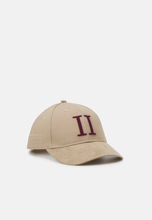 Casquette de baseball beige avec une visière courbée et le chiffre romain II en rouge foncé brodé sur le panneau avant.