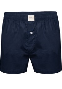 Boxers en coton bleu marine avec une taille élastique, fermeture à bouton à l'avant et une texture lisse. Étiquette visible au niveau de la taille.