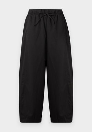 Μαύρο παντελόνι φαρδιάς γραμμής με ελαστική μέση και κορδόνι, μήκος έως τον αστράγαλο, απλός σχεδιασμός, χωρίς ορατές τσέπες ή σχέδια.