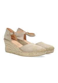 Beige suede espadrille wedges with ankle straps, jute-wrapped heel, round toe, and a textured braided sole.