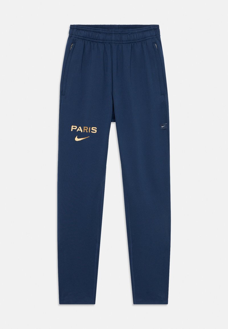 Pantaloni atletici bleu marin din material moale, cu text aurit "PARIS", un logo Nike pe coapsa stângă și buzunare laterale cu fermoar.