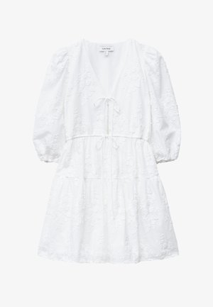 White short dress with puffed sleeves, V-neck, embroidered floral pattern, and two front tie strings at waist and chest.