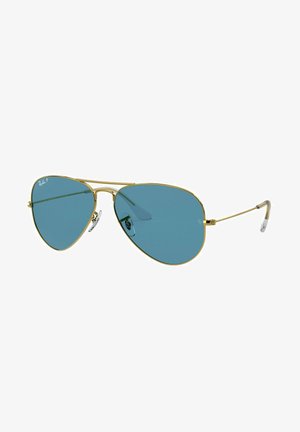 Occhiali da sole aviator con montatura in metallo dorato, lenti specchiate blu e cuscinetti nasali in silicone trasparente. Templi sottili con design a cerniera.