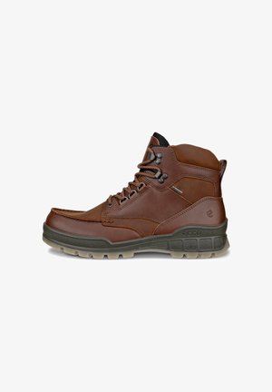 Brauner Leder-Knöchelstiefel mit schwarzen Schnürsenkeln, Metallösen, gepolstertem Kragen und strukturierter dunkelgrauer Sohle, die für den Außenbereich entwickelt wurde.