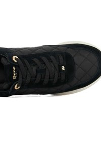 Black sneaker with quilted texture, suede material, gold eyelets, and black laces, featuring a cream-colored sole and embossed logo.