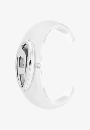 Bracelet manchette de montre blanc avec cadran ovale argenté et design minimaliste, couronne latérale pour réglage de l’heure, bracelet incurvé ouvert.