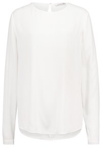Vit långärmad blus med rund halsringning, tillverkad av ett mjukt tyg. Har en subtil struktur och en något böjd fåll längst ner.