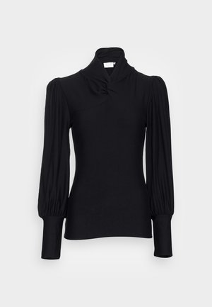 Black long-sleeve top with a high neck, featuring gathered shoulders and fitted sleeves. Made from a smooth, stretchy material.
