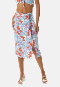 Floral wrap skirt featuring a light blue background with red and orange flowers, side slit, and tie closure for adjustable fit.