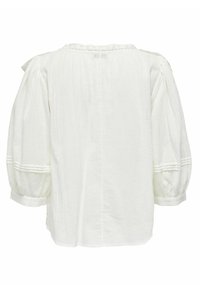 Weiße Bluse mit lockerer Passform, gepufften Ärmeln und strukturierten Details am Ausschnitt und den Ärmelbündchen. Aus Leinen oder Baumwolle.