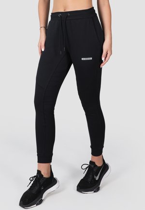 Black athletic leggings with a fitted design, textured panel accents, elastic waistband with drawstring, and small logo detail on the front.