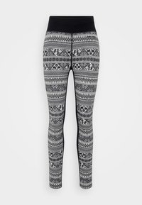 Black and white patterned knit leggings with a high black waistband and intricate geometric and animal motifs throughout.