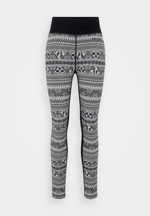 Black and white patterned knit leggings with a high black waistband and intricate geometric and animal motifs throughout.