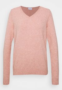 Persikofärgad V-ringad tröja med långa ärmar, ribbad nederkant och en mjuk, strukturerad yta. Enkel design utan mönster eller accenter.