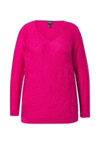 Różowy sweter z dekoltem w serek, z długimi rękawami, o teksturowanym splocie i subtelnym blasku. Charakteryzuje się luźnym krojem oraz ściągaczami na mankietach i u dołu.