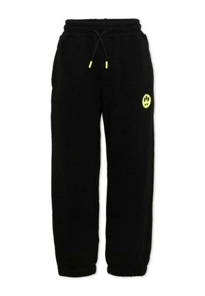 Czarne spodnie dresowe z elastycznym pasem i ściągaczami, neonowożółte końcówki sznurka oraz małe logo uśmiechniętej buźki w neonowożółtym kolorze na lewej części uda.