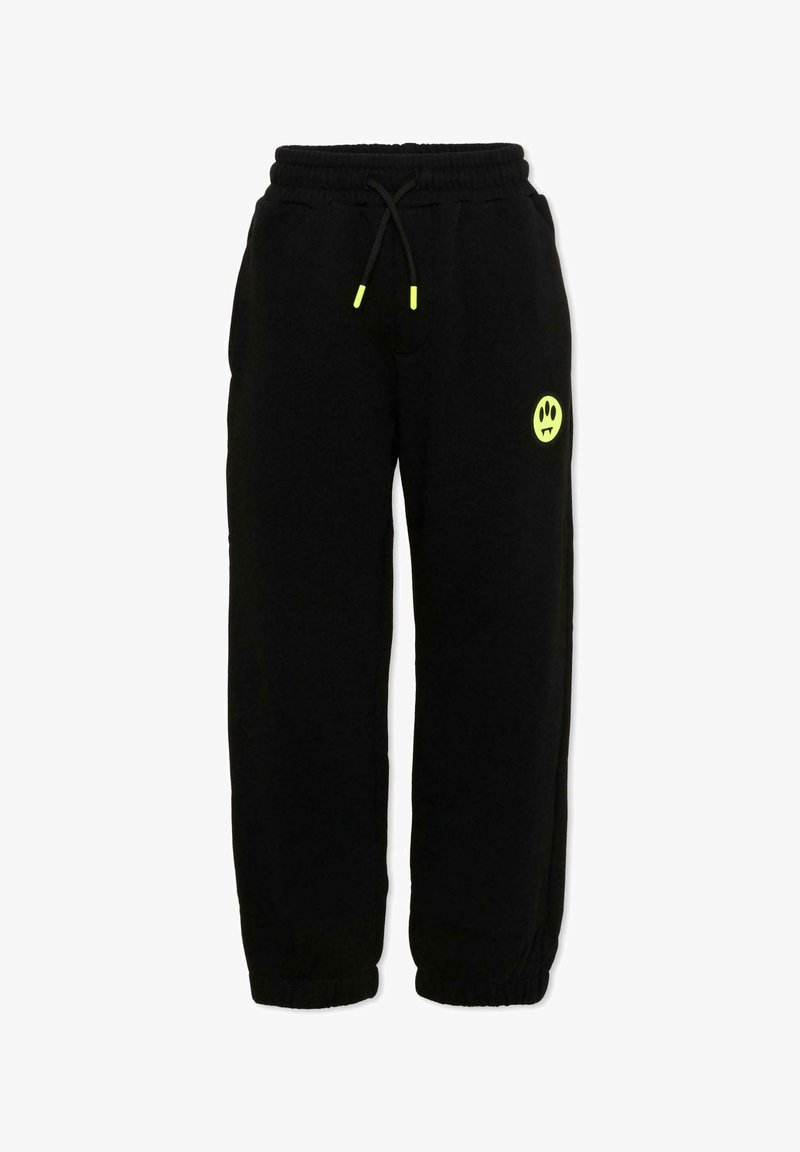 Pantalon de survêtement noir avec taille et chevilles élastiques, embouts de cordon de serrage jaune néon, et petit logo smiley jaune néon sur la cuisse gauche.