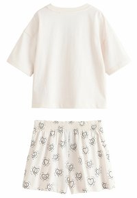 Hvid bomulds to-delt sæt med en kortærmet top og shorts med et sort hjerte og smiley print. Elastisk talje på shorts.
