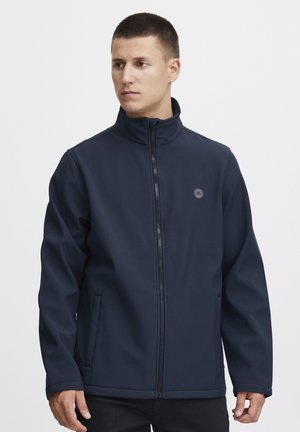 Navy blue jacket with a high collar, front zipper, two side pockets, and a small logo on the chest. Made from a smooth, durable fabric.