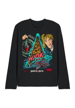 Black long-sleeve shirt with colorful graphic of a radio tower, a hand on a lever, a girl’s face, and a monstrous creature, referencing Stranger Things.