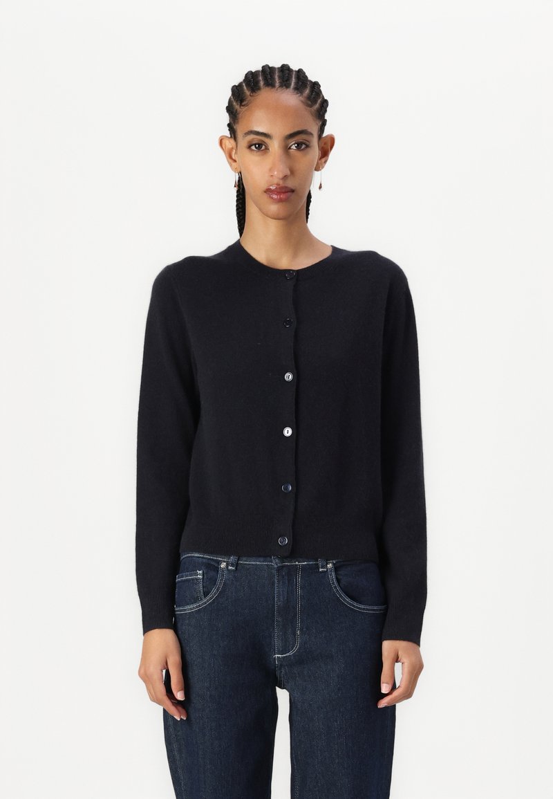 Black cardigan made of soft fabric, round neckline, and long sleeves. Features a button closure down the front with contrasting buttons.