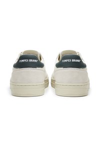 White and grey suede sneakers with a textured finish, featuring a dark green heel tab and branding. Minimalist design with flat laces.