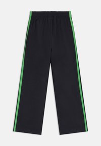 Black pants with a wide leg design, featuring green side stripes and an elastic waistband. Material appears smooth with no visible patterns.