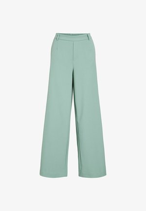 Mintzaļas plašas bikses ar gludu audumu, elastīgu jostasvietu, viltus priekšējām kabatām un piegriezumu, kas nodrošina ērtu fitu.