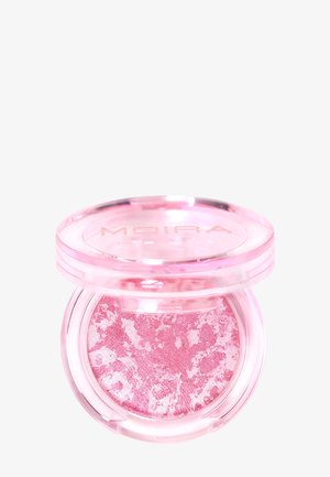 Petit contenant rond avec blush en poudre marbré rose et blanc, couvercle transparent rose partiellement ouvert, marque "MOIRA" visible sur le couvercle.