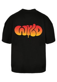 Black short-sleeve t-shirt featuring a large gradient text "WYKD" in orange and red tones on the back. Soft fabric, relaxed fit.