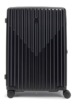 Black hard shell suitcase with vertical ridges, featuring a triangular logo, four wheels, and side handles for easy mobility.