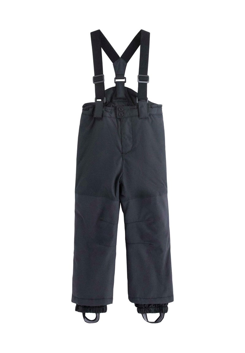 Pantalon de neige isolé noir avec bretelles élastiques réglables et guêtres de cheville avec sangles pour les pieds.