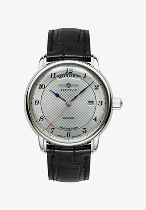 Automatic watch with a silver textured dial, black leather strap, blue hour and minute hands, and date display at 6 o'clock.