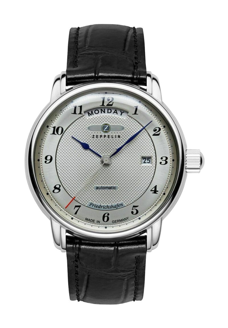 Automatic watch with a silver textured dial, black leather strap, blue hour and minute hands, and date display at 6 o'clock.
