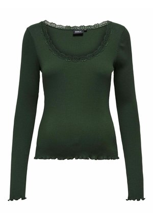 Haut côtelé vert foncé à manches longues avec encolure dégagée bordée de dentelle et ourlet et poignets à bords ondulés, coupe maternité.