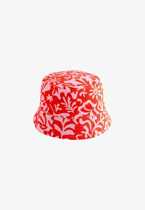 Red and white patterned bucket hat with floral motifs, made of fabric, featuring a wide brim and a rounded crown.