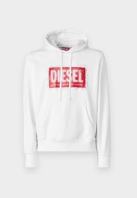 Vit hoodie med en röd sliten "DIESEL"-logotyp, dragsko på huvan och en framficka i känguru-stil. Mjuk tygkvalitet, ribbade ärmslut.