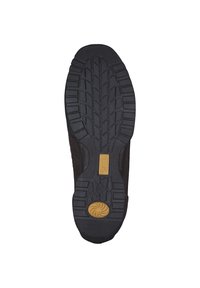 Schwarze Gummisohle mit strukturiertem Profil, featuring einem kreisförmigen gelben Akzent und einer im Design eingebetteten Logoplatte.