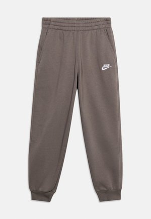 Pantalon de survêtement Nike gris avec taille élastique, poches latérales, bas de jambes côtelés et logo blanc Nike sur la cuisse gauche.