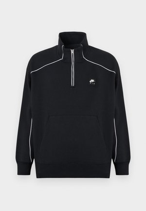 Black fleece pullover with a quarter-zip collar, white accent stitching, a central kangaroo pocket, and a black Nike Air logo patch.