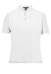 Bílá blouse s krátkým rukávem vyrobená z lehkého materiálu, s tečkovanou texturou, volánkovým výstřihem a uvázáním vpředu.