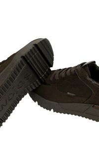 Sneaker in suede marrone con dettagli testurizzati, suola in gomma e collo imbottito di supporto. Presenta lacci e un pannello logo discreto.