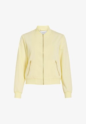 Blouson bomber zippé jaune clair avec col, poignets et ourlet côtelés, comprenant deux poches diagonales zippées à l'avant.