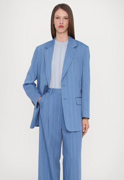 Blue pinstriped suit with a tailored blazer and matching wide-leg trousers. The blazer features a single pocket and subtle texture.